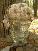SOLD OUT NONE LEFT: This weighs 1 1/2 # The bun cushion is attached to a heavy large vintage electrical insulator the fabric used is reproduction Civil War design.  Completely hand made.  There are several of these still available.  Each made with reproduction fabric.  The fabric will differ on each one.  They are each Wonderful! CLICK on picture to enlarge!